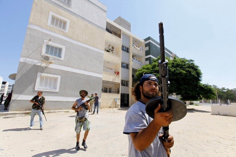 Rebel fighters scout for snipers in the final push to flush out Muammar Gaddafi's forces in Abu Slim in Tripoli