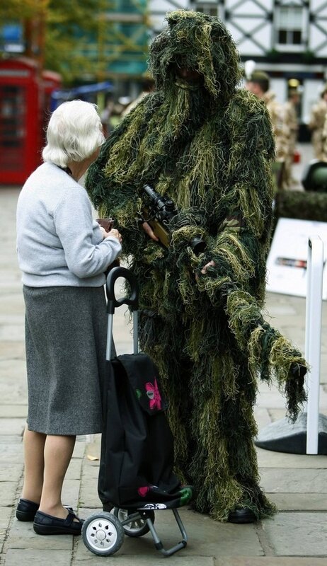 A woman talks with a sniper from 1st Battalion The Royal Welsh in Chester, northern England