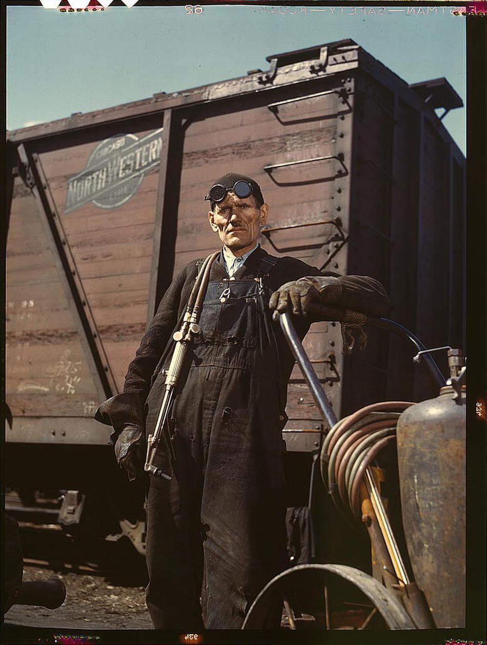 Mike Evans, a welder, at the rip tracks at Proviso yard of the Chicago and Northwest Railway Company. Chicago, Illinois, April 1943. Reproduction from color slide. Photo by Jack Delano. Prints and Photographs Division, Library of Congress