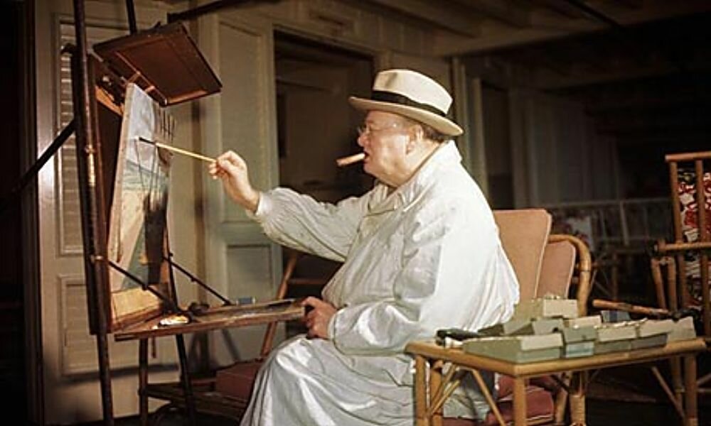 Winston Churchill painting at his easel February, cigar clamped firmly in his mouth. Photograph: Bettmann/Corbis