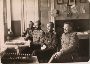 Группа офицеров авиароты заведующий хозяйством капитан Карачаев, казначей Алабовский (слева), делопроизводители Белоусов (3-й слева) и Землянкин - в канцелярии роты.