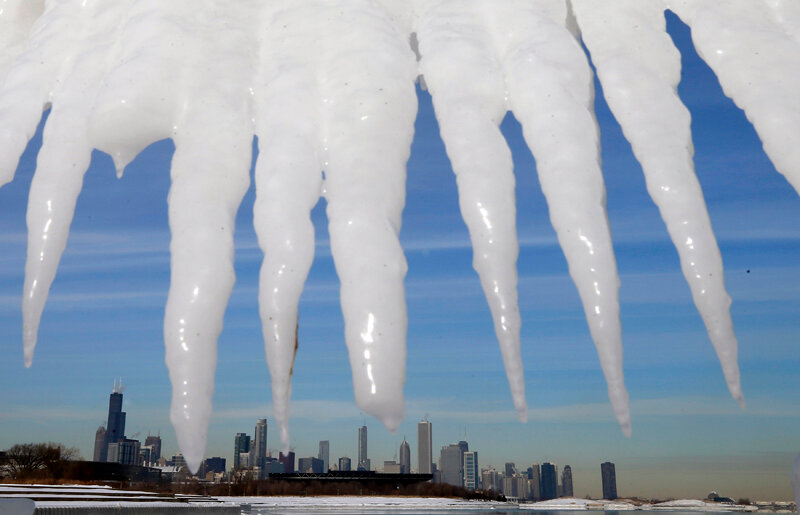 The Chicago skyline is framed by icicles in Chicago, Illinois, January 8, 2014. A deadly blast of arctic air shattered decades-old temperature records as it enveloped the eastern United States on Tuesday, snarling air, road and rail travel, driving energy
