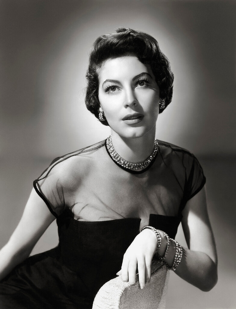 circa 1950: Studio portrait of American actor Ava Gardner (1922 - 1990) wearing a black dress with a net bodice and diamond jewelry.