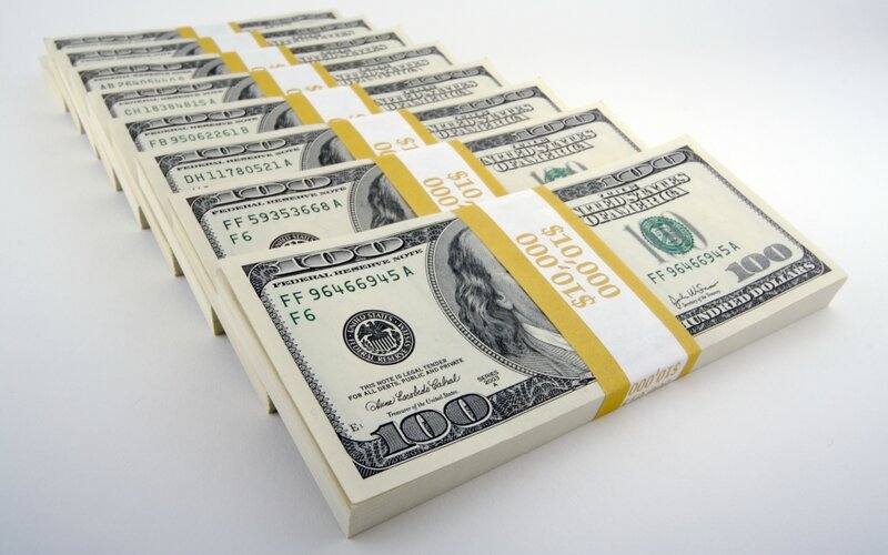 Row of Stacks of One Hundred Dollar Bills