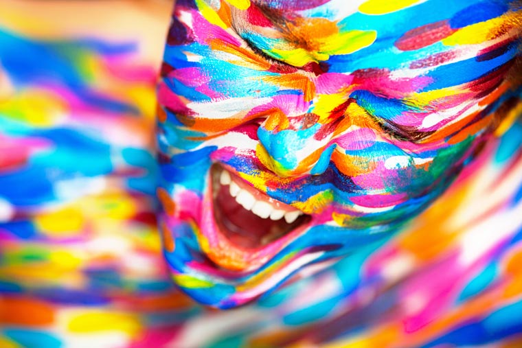 Portrait of the bright beautiful girl with art colorful make-up and body art