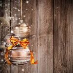 Christmas theme with golden glass balls on blur wooden texture