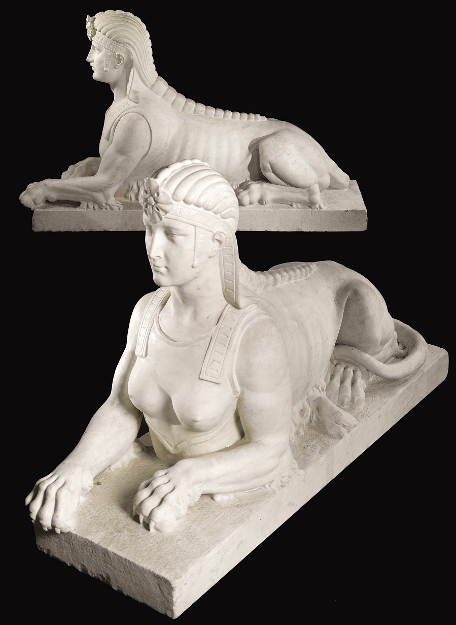 A large pair of carved white marble sphinxes